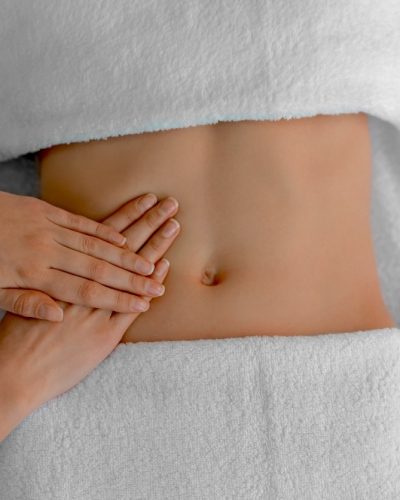Woman receiving professional belly massage, closeup view